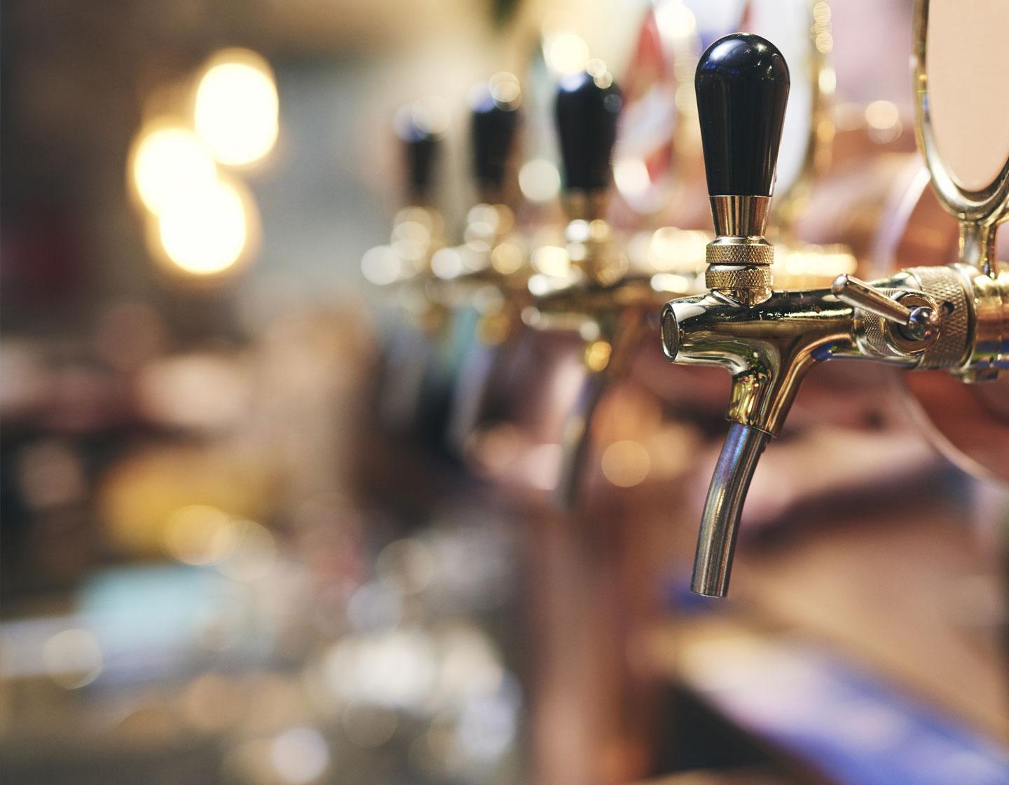 Row of beer taps in a bar