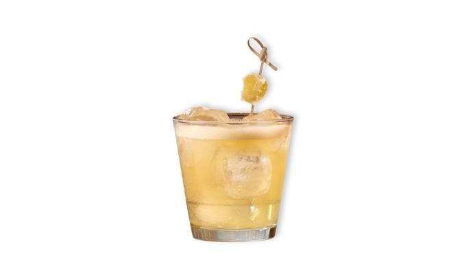 Johnnie Walker Penicillin Cocktail yellow liquid in rocks glass with candied ginger garnish