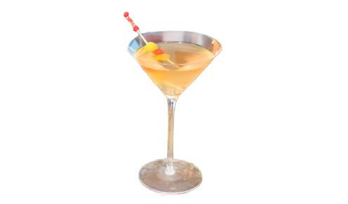 An orange-tinted martini cocktail with a red and orange pickle garnish, and a bottle of Don Julio tequila on a wooden table.
