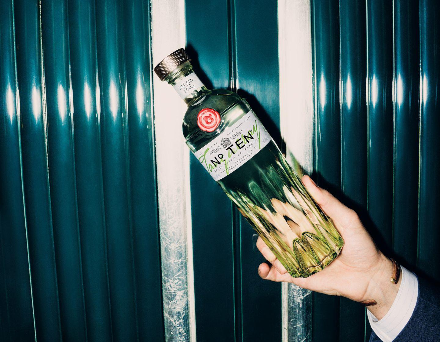 Tanqueray No. TEN bottle in hand.