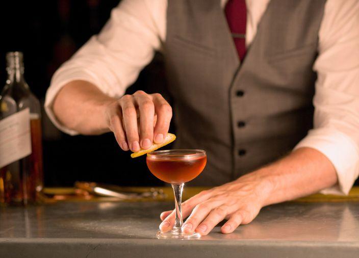 Premium cocktail being prepared by a bartender.