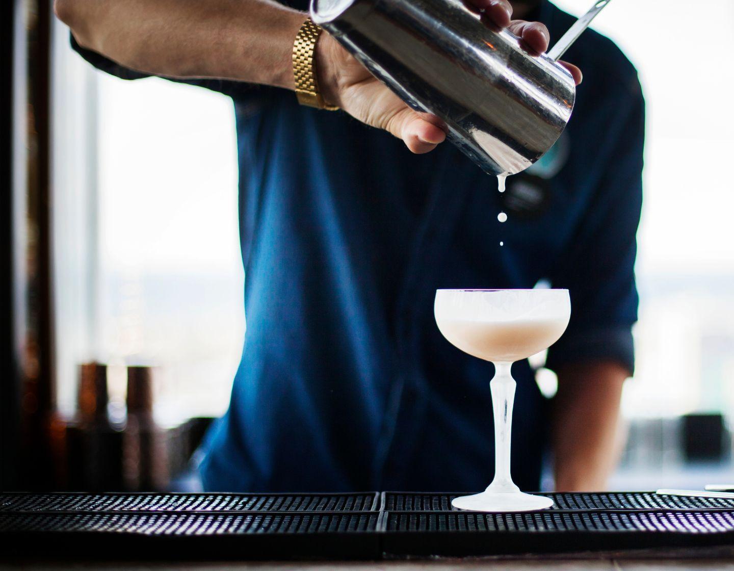 Server bringing drinks to a table of guests