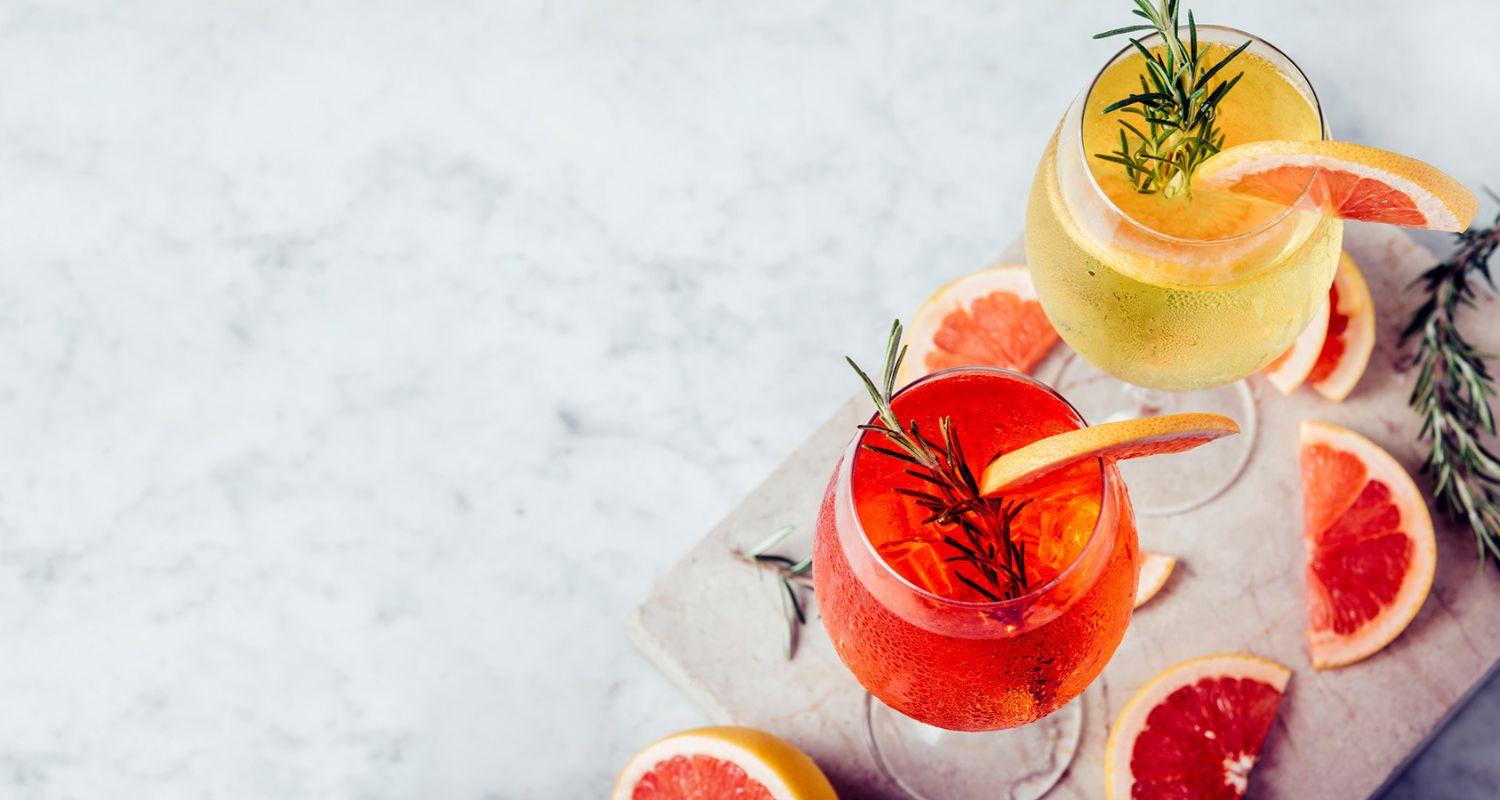 Cocktail on table garnished with fruit