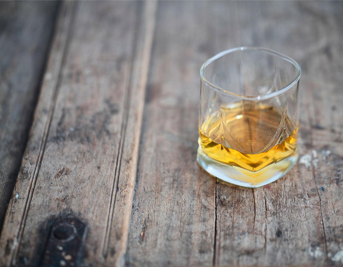 Glass of Whisky on wooded table