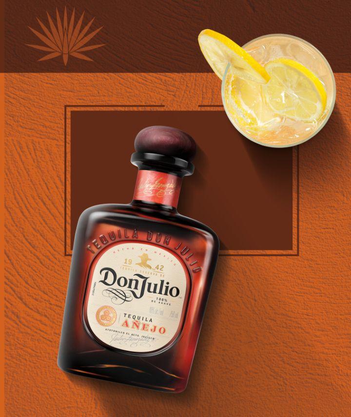 Bottle of Don Julio Añejo with cocktail with lemon wedge