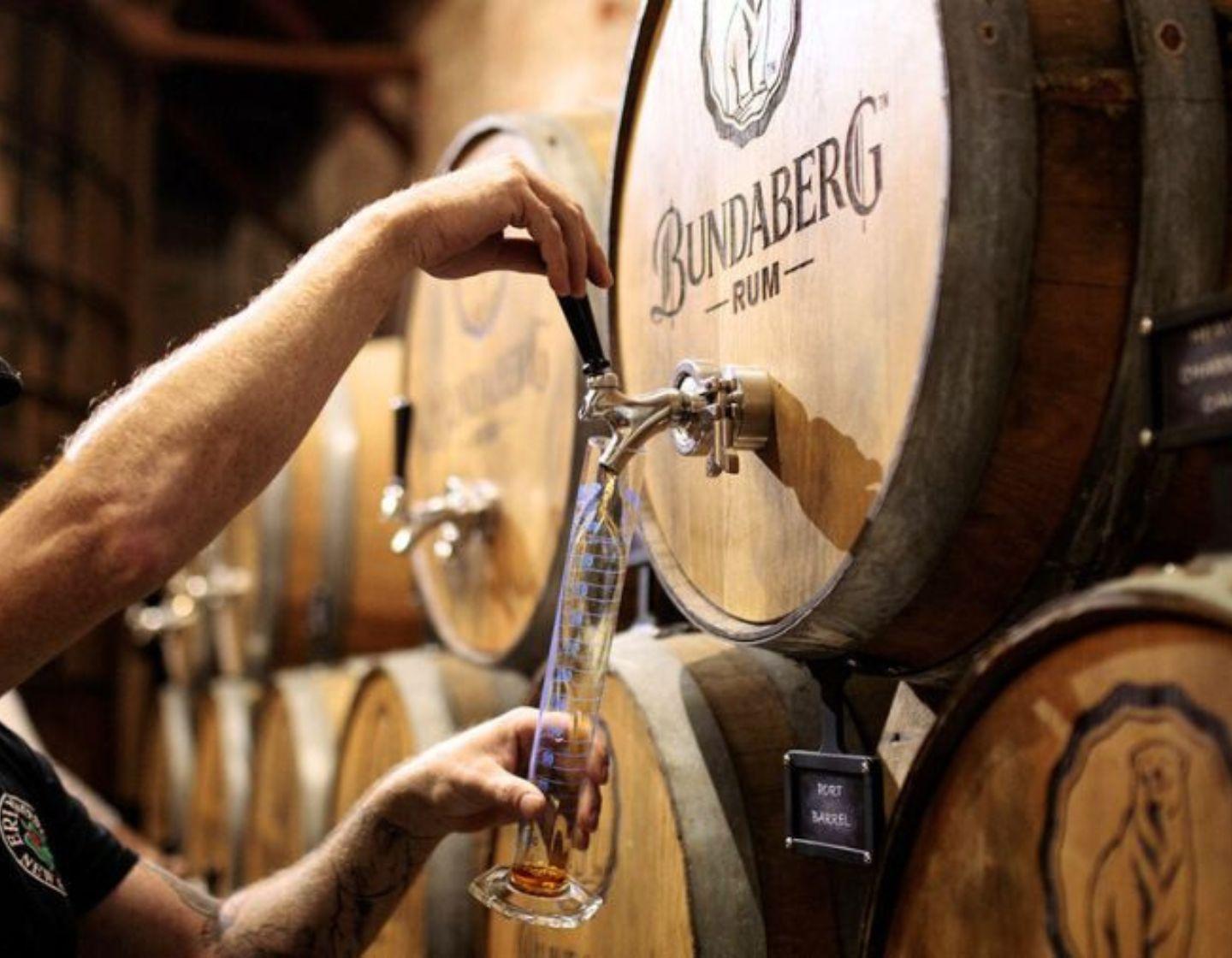 Liquid being poured from a wooden cask.