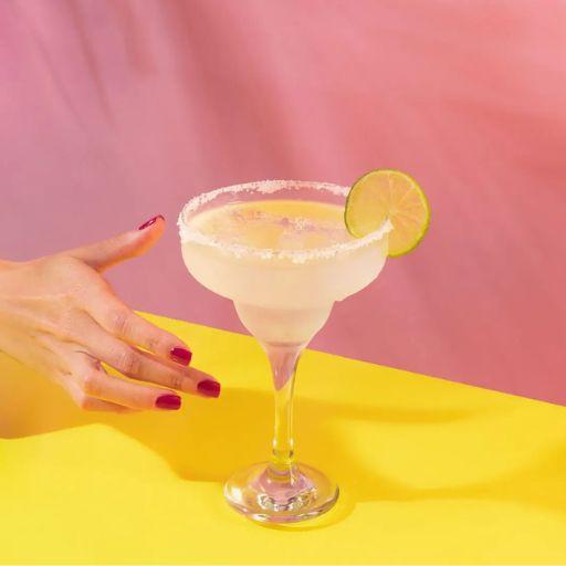 Serve of strawberry margarita cocktail with strawberries on the side 