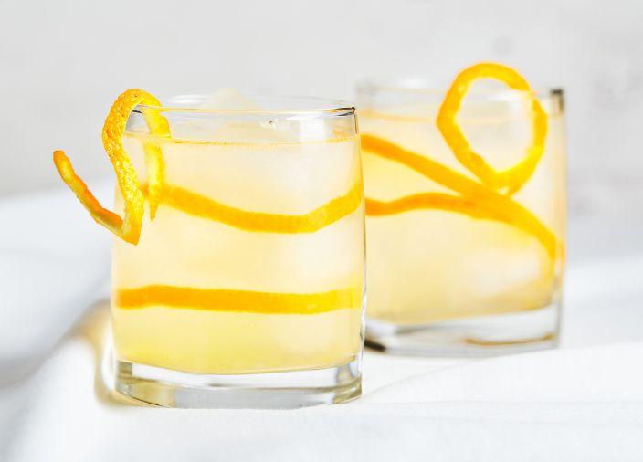Gin cocktails with orange peel.