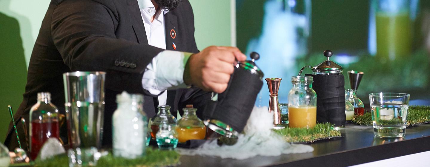 Bartender pouring theatrical cocktails