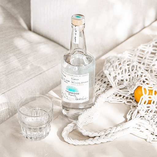 Cocktail bottle with glass on table