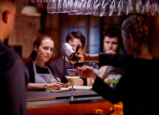 Bar manager training bar team making cocktails
