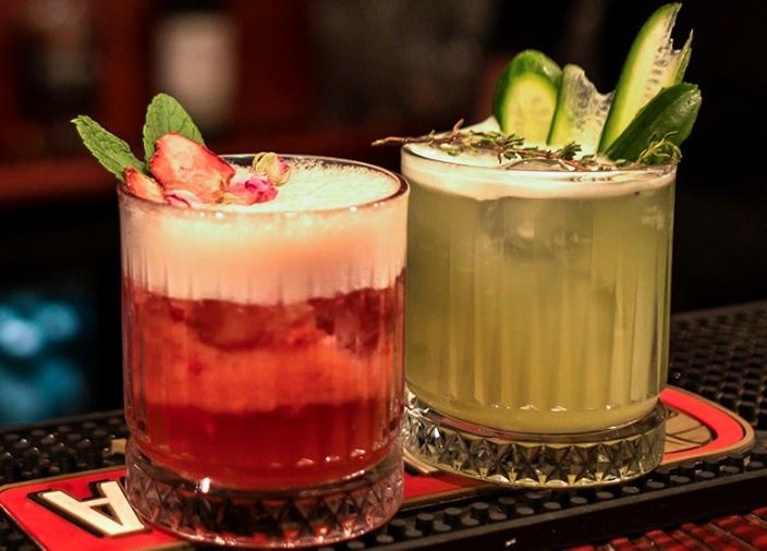 Two cocktails with foam and air and garnishes