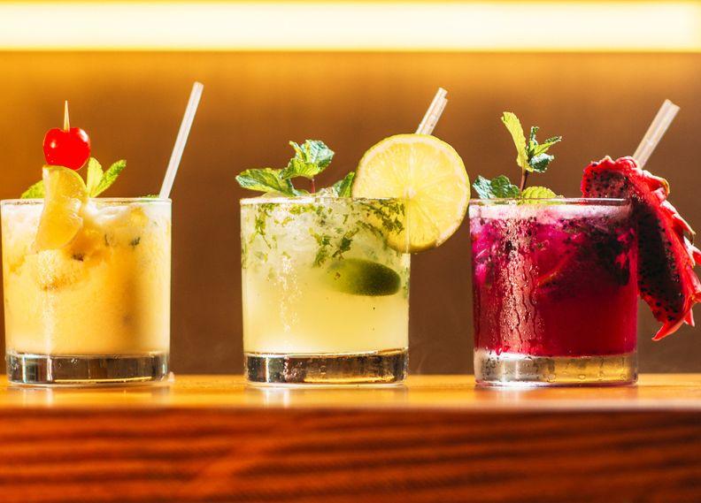 three cocktails presented on bar