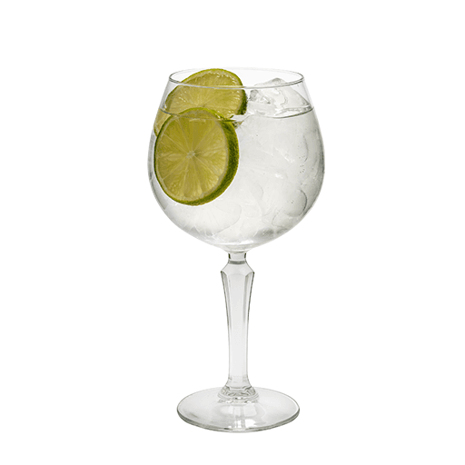 Green Sting cocktail in a large wine glass with lime garnish