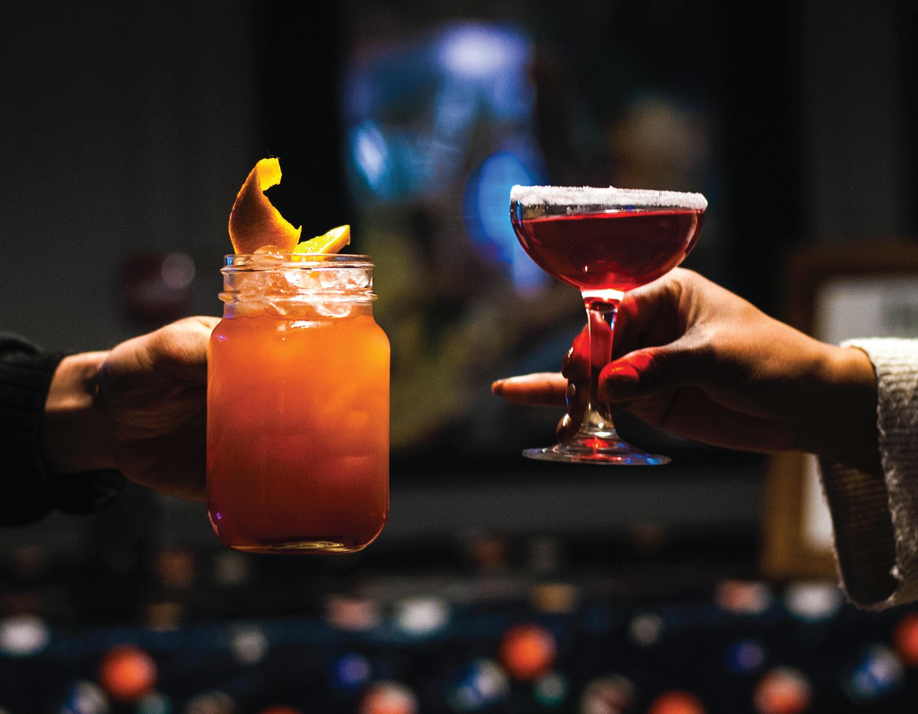 Two cocktails in hand.