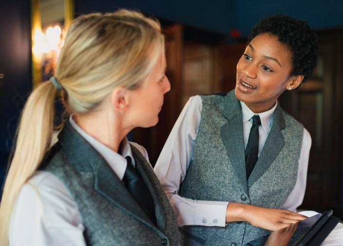 BAR MANAGER TALKING TO BARTENDER