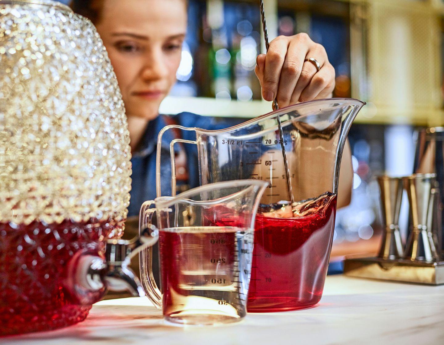 Bartender mixing a batched cocktail
