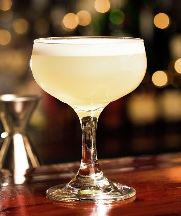 White Lady cocktail, yelllow liquid in coupe glass