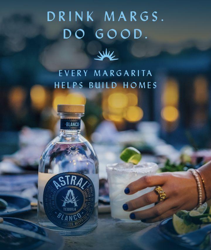 Astral margarita and bottle on table