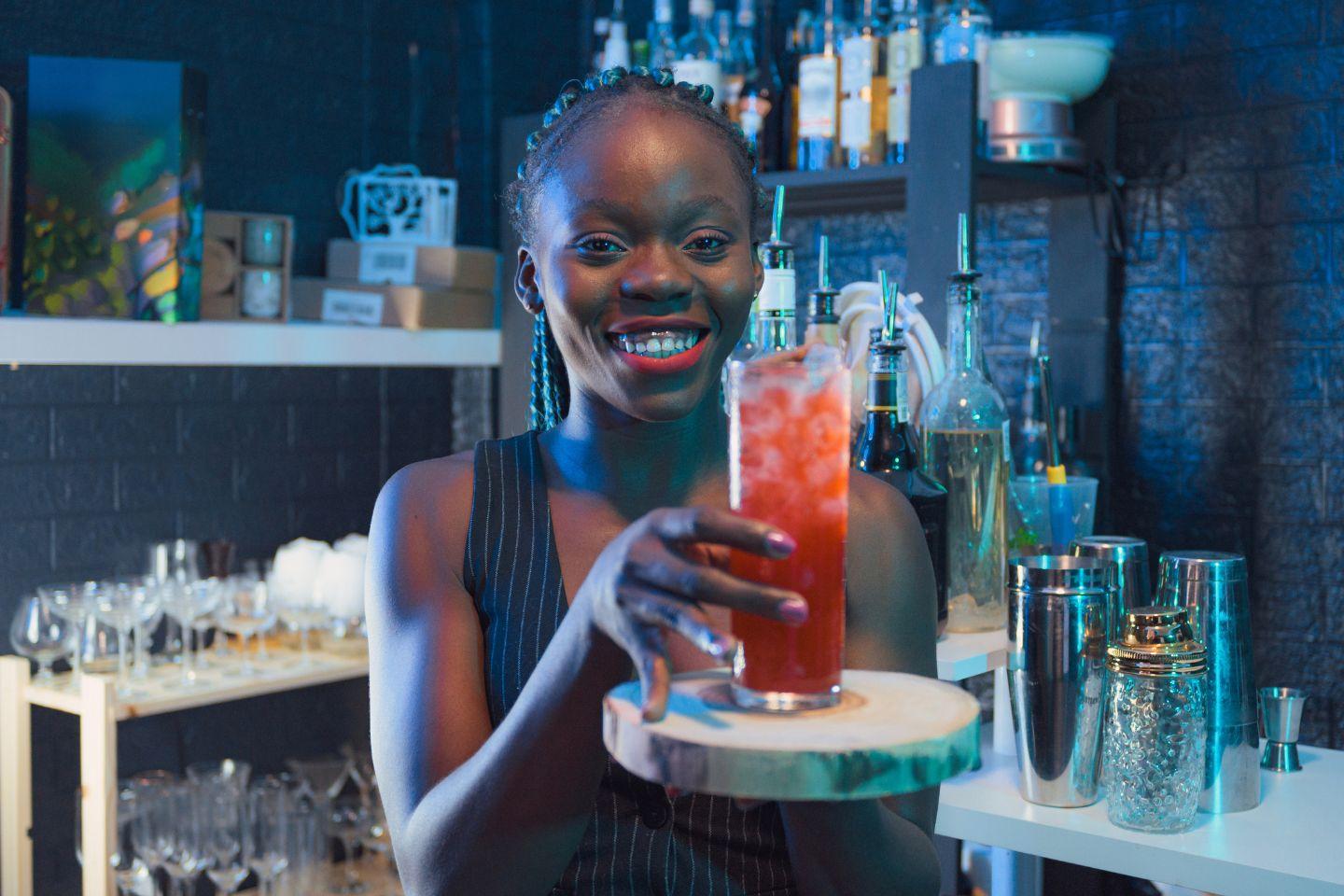 bartender mostrando o coquetél no bar