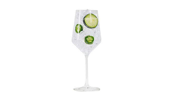 21Seeds Seed + Soda cocktail in a wine glass with lime wheel garnish