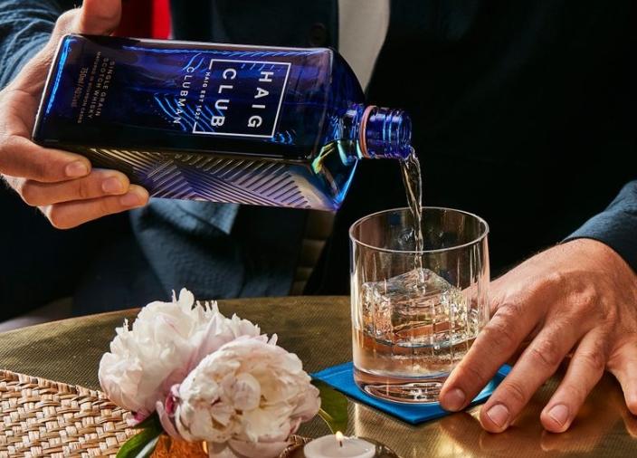 Man pouring a serve from Haig Club bottle