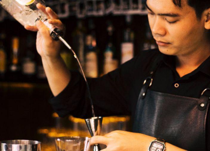 Bartender pouring liquid using speed pourer