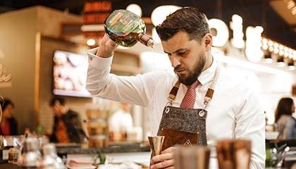 Bartender pouring Buchanans in a shaker