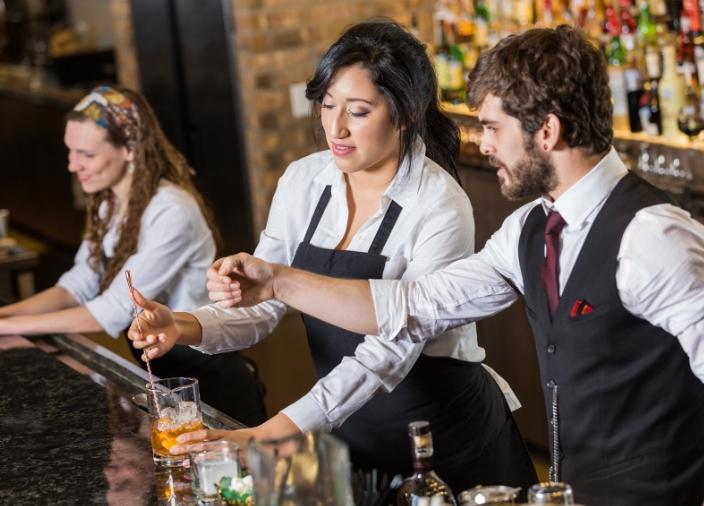 BARTENDERS WORKING BEHIND BAR