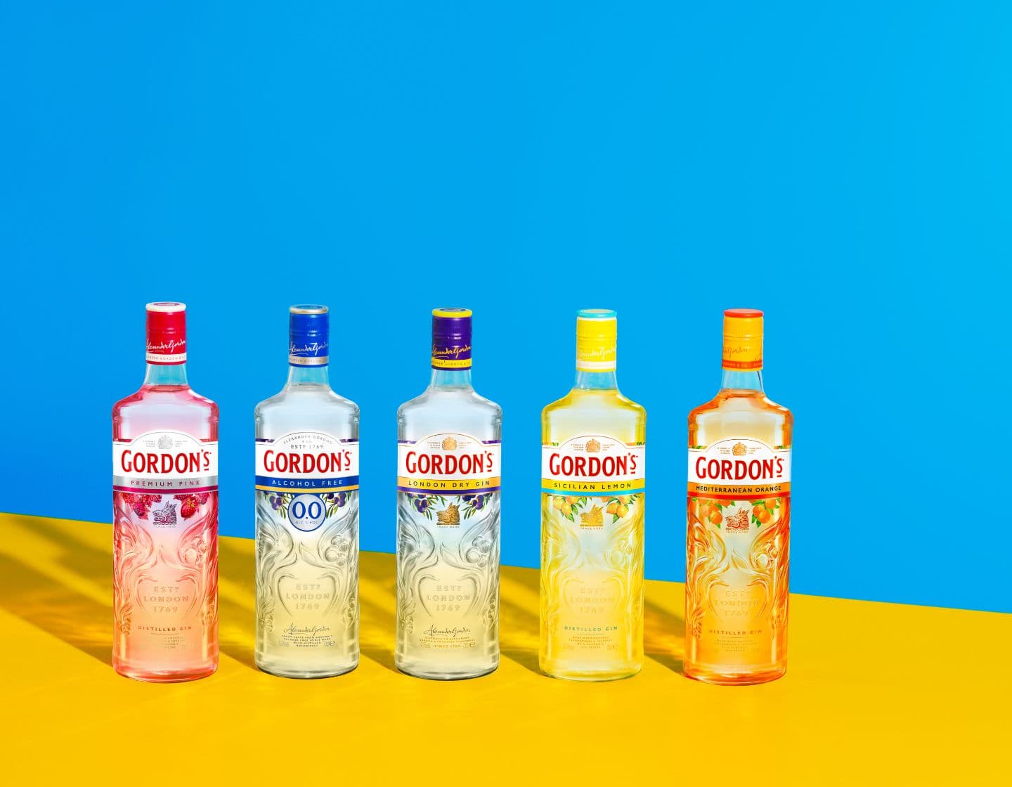 All Gordon’s gin variants lined up against a blue and yellow background. 