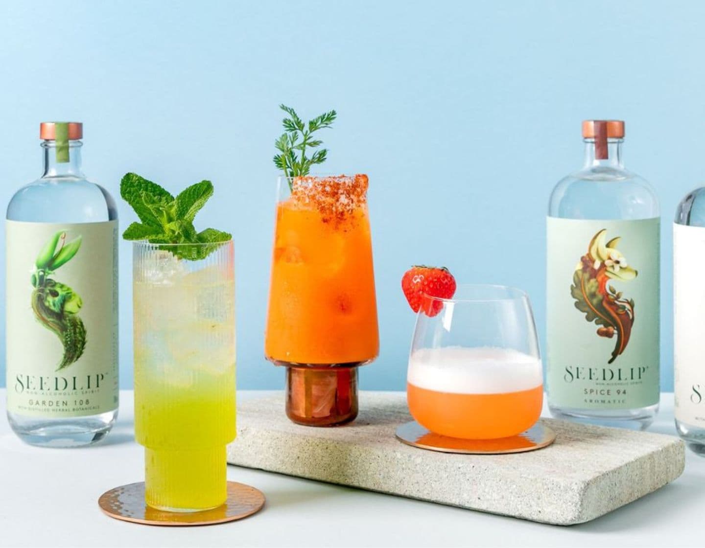 Selection of Seedlip bottles on table surrounded by assorted cocktails