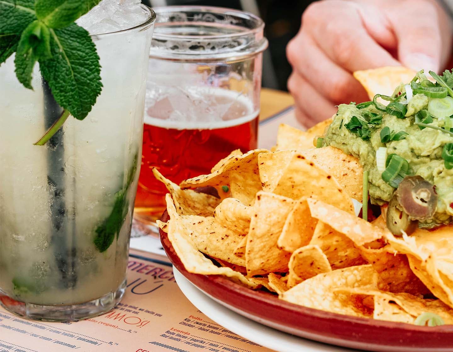 Two cocktails and a plate of Nachos