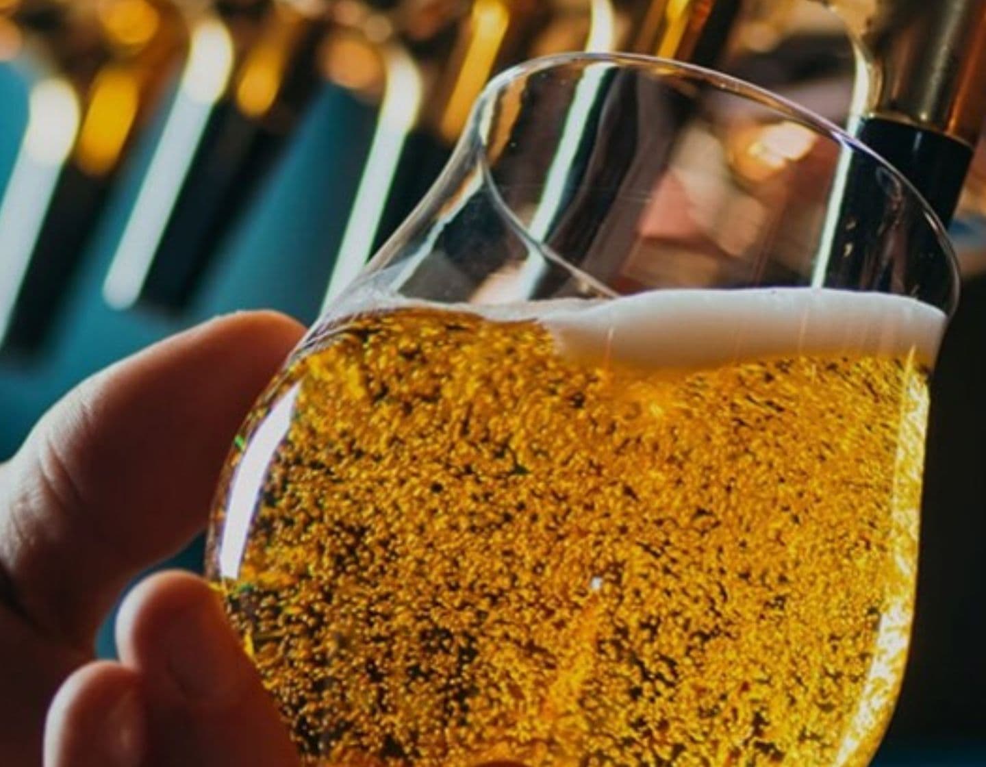 A close up of a beer being poured on tap. 