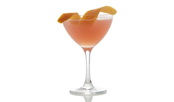 Cocktail in a coupe glass with orange twist