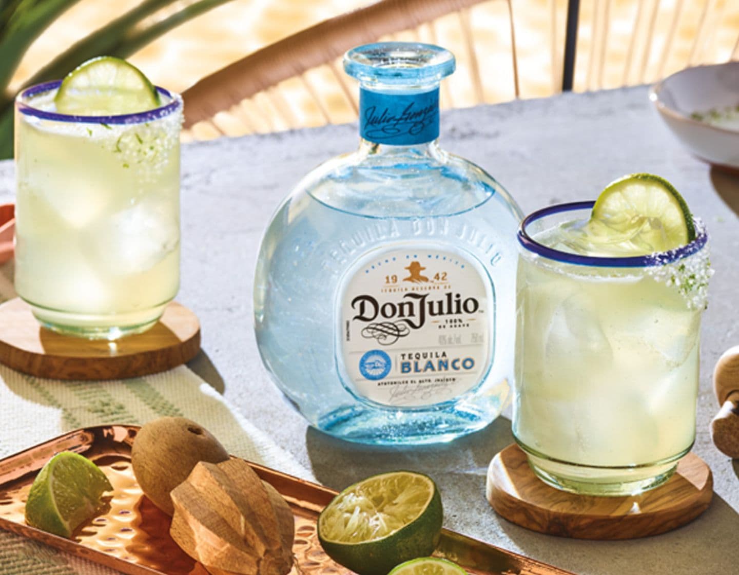 Bottle of Don Julio Tequila between two tequila cocktails 