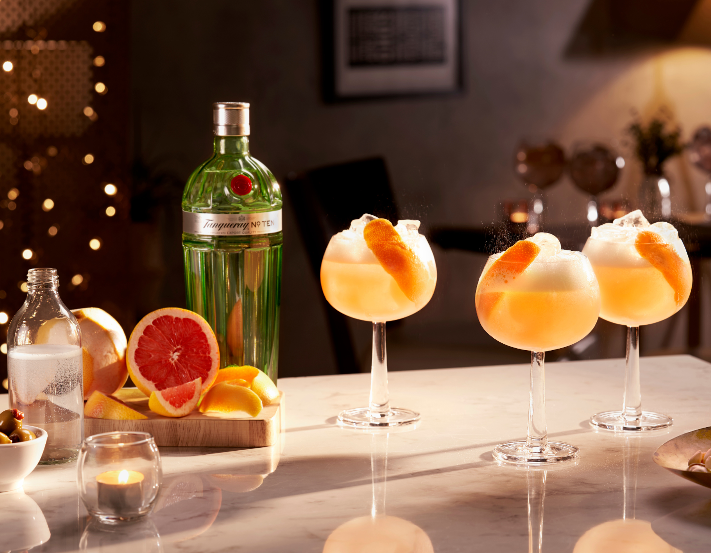 Tanqueray Gin Cocktails with Bottle of Tanqueray Gin in a seasonal Christmas Setting 