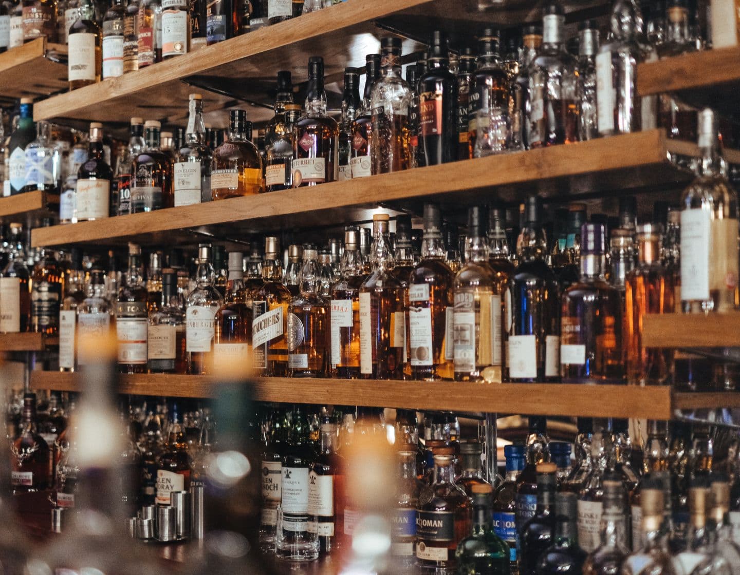 Multiple shelves filled with whisky bottles 