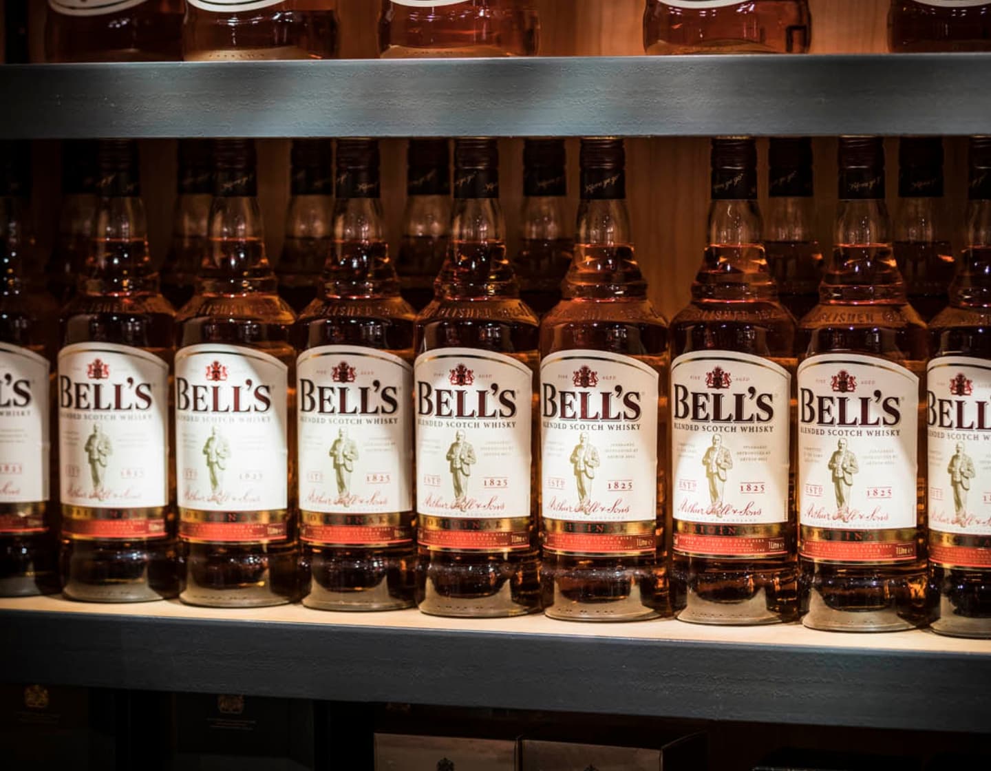 Row of Bell's whisky bottles