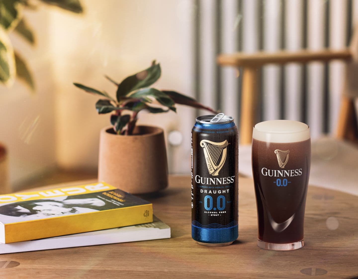 Can of Guinness 0.0 on countertop beside pint glass filled with Guinness 0.0