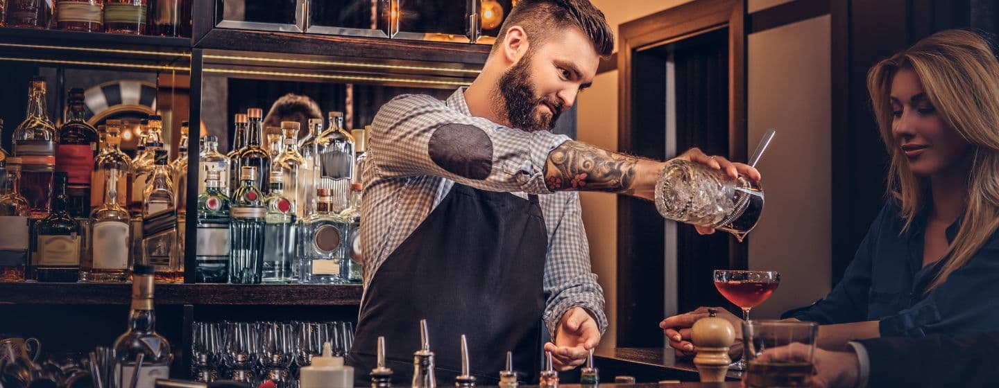 Imagem de um bartender servindo coquetél no bar 