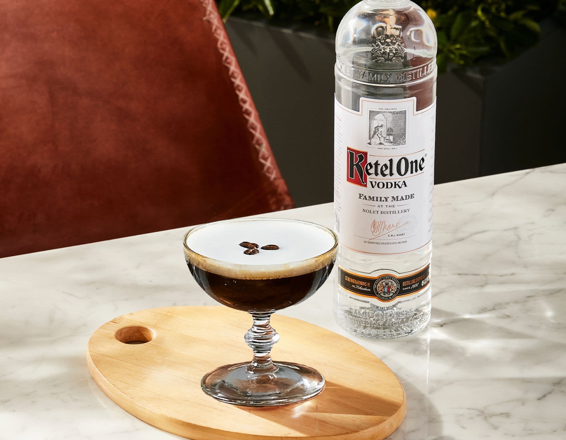 An espresso martini and a French martini next to a bottle of Ketel One Vodka.