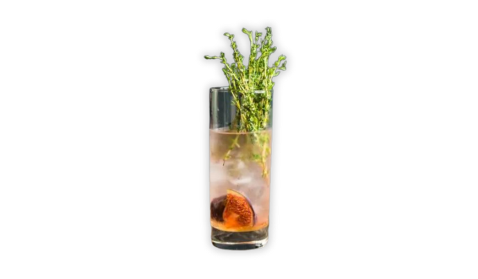 Highball glass filled with whisky cocktail garnished with thyme and fig
