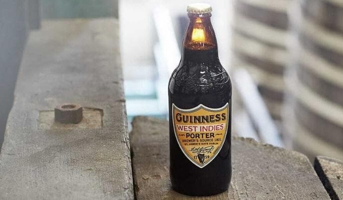 Bottle of Guinness West Indies Porter on wooden boards